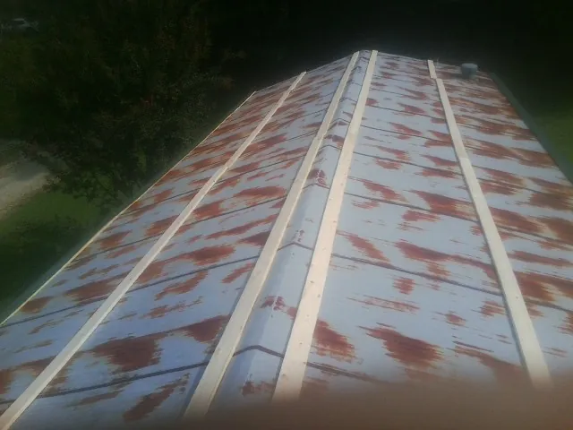 Rusted metal roof panels with new wood purlins before replacement — Storm Damage Roof Repair in Oakhurst by Roofing Brothers
